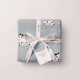 Dalmatian muslin swaddle folded and tied with tag and ribbon